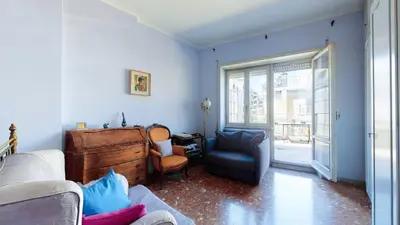 a living room with a couch and a chair at FIORELLA's TERRACE in Rome