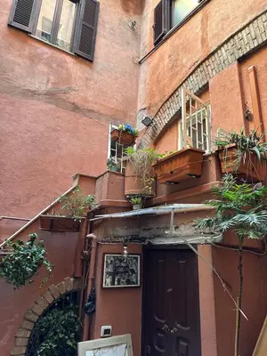 an entrance to a building with potted plants and a door at Arco Acetari - The Middle Ages in the heart of Rome in Rome