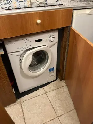 a washer and dryer in a small room at Arco Acetari - The Middle Ages in the heart of Rome in Rome