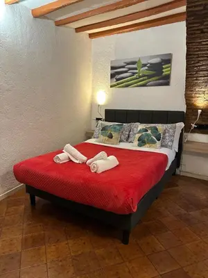 a bedroom with a bed with two towels on it at Arco Acetari - The Middle Ages in the heart of Rome in Rome
