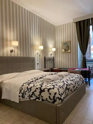 a bedroom with a large bed in a room at SUNSHINE ROOMS 1s in Rome