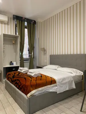 a bedroom with a bed with a tiger blanket at SUNSHINE ROOMS 1s in Rome