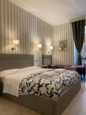 a bedroom with a large bed in a room at SUNSHINE ROOMS 1s in Rome