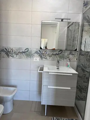 a bathroom with a sink and a mirror at Home in Roma in Rome