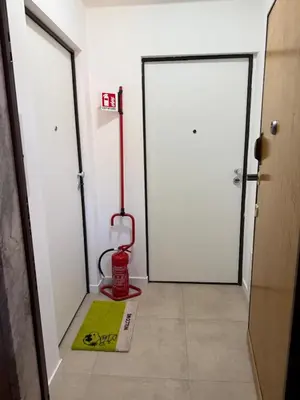 a room with a white door and a red vacuum at Home in Roma in Rome