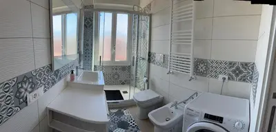 a bathroom with a sink and a washing machine at Home in Roma in Rome