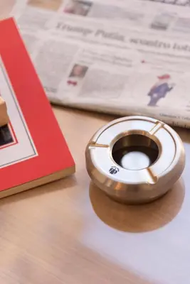 a metal object on a table next to a book at Chessa's Rooms in Rome