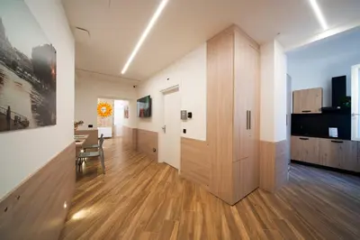 a hallway with a wooden door and a dining room at Chessa's Rooms in Rome
