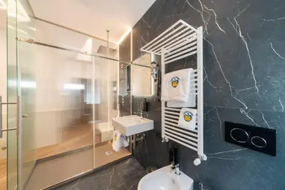 a bathroom with a sink and a toilet at Chessa's Rooms in Rome