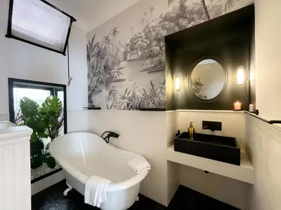 a bathroom with a bath tub and a mirror at Monti Mood Design Apt - via Urbana - BRAND NEW in Rome