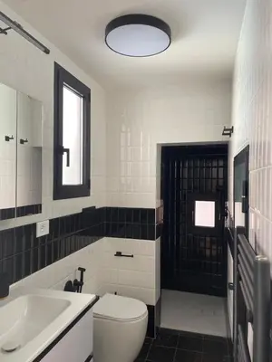 a bathroom with a white toilet and a sink at Monti Mood Design Apt - via Urbana - BRAND NEW in Rome