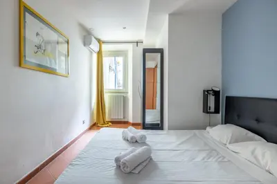 a bedroom with a bed with towels on it at Casa Vacanza trastevere in Rome