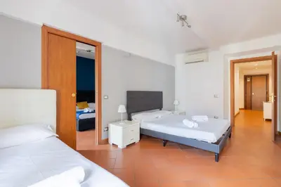 a bedroom with two beds and a mirror at Casa Vacanza trastevere in Rome