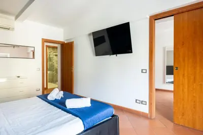 a bedroom with a bed and a flat screen tv at Casa Vacanza trastevere in Rome