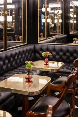 two tables and chairs with flowers on them in a restaurant at Hotel d’Inghilterra Roma – Starhotels Collezione in Rome