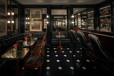 a restaurant with tables and chairs and a bar at Hotel d’Inghilterra Roma – Starhotels Collezione in Rome