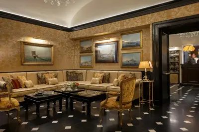 a living room with a couch and a table at Hotel d’Inghilterra Roma – Starhotels Collezione in Rome