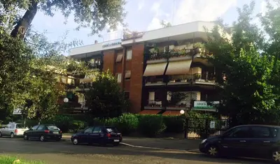 a building with cars parked in front of it at B&B Viale Dei Colli Portuensi 589 in Rome