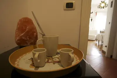 a plate with three cups on a table at B&B Viale Dei Colli Portuensi 589 in Rome