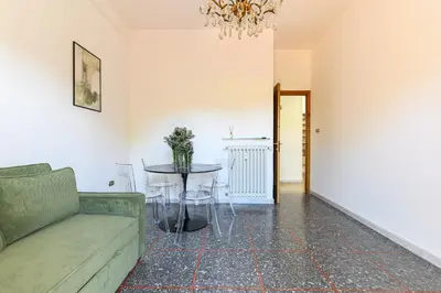 a living room with a couch and a table at NEW Diana's place with terrace San Pietro Station in Rome