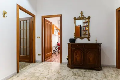 a hallway with a mirror and a wooden dresser at NEW Diana's place with terrace San Pietro Station in Rome