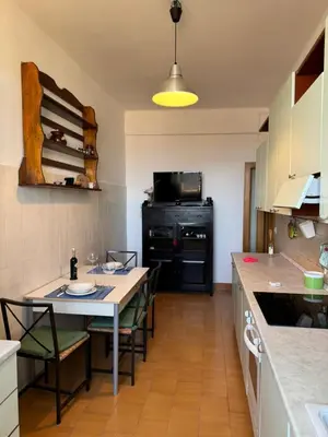a kitchen with a table and chairs in a kitchen at House - Furio Camillo - Too in Rome