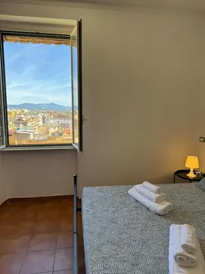 a bedroom with two beds and a large window at House - Furio Camillo - Too in Rome