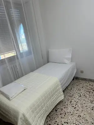 a white bed in a room with a window at Roma Guest house Aversa 55 in Rome