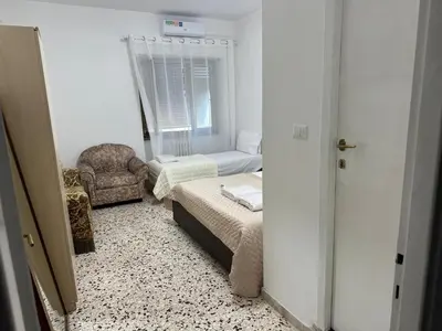 a small room with a bed and a chair at Roma Guest house Aversa 55 in Rome