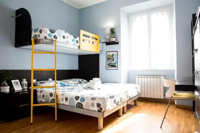 a bedroom with a bunk bed and blue walls at Chat&Chill Vatican Apartment in Rome
