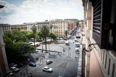 a view from a window of a city street with cars at Chat&Chill Vatican Apartment in Rome