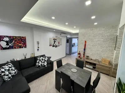 a living room with a black couch and a table at Banksy Urban Suite in Rome