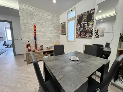 a dining room with a table and chairs at Banksy Urban Suite in Rome