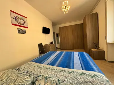 a bedroom with a large bed with a blue comforter at Banksy Urban Suite in Rome