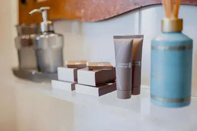 a bathroom counter with a bottle of soap and other items at Elegantis Monti Penthouse With Private Terrace and Colosseum View in Rome