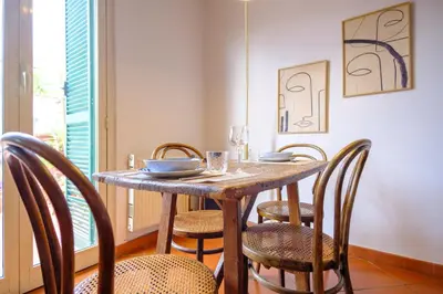 a dining room with a wooden table and chairs at Elegantis Monti Penthouse With Private Terrace and Colosseum View in Rome