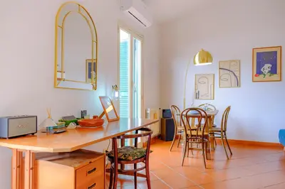 a kitchen and dining room with a table and chairs at Elegantis Monti Penthouse With Private Terrace and Colosseum View in Rome