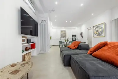 a living room with two couches and a tv at Skylife Garden of Olives in Rome