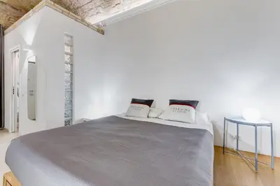 a white bedroom with a large bed with two pillows at Vatican Scipioni Charming Studio relaxing and patio in Rome