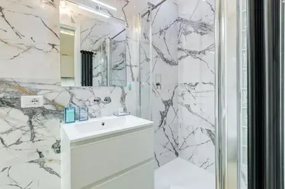 a white bathroom with a sink and a mirror at Vatican Scipioni Charming Studio relaxing and patio in Rome