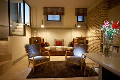 a living room with two chairs and a couch at Vatican design loft in Rome