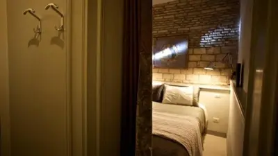 a bedroom with a bed in a room with a brick wall at Vatican design loft in Rome