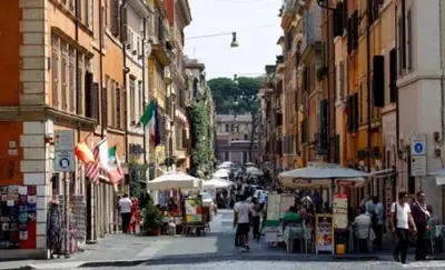 a group of people walking down a street with buildings at Vatican design loft in Rome