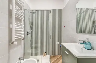 a bathroom with a shower and a sink and a toilet at Albadoro Apartment in Rome