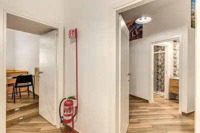 a hallway with a fire extinguisher in a room at Albadoro Apartment in Rome