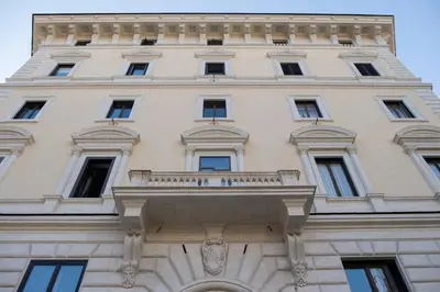 a tall building with a balcony on top of it at Caesarina Roma, Luxury apartment in Rome