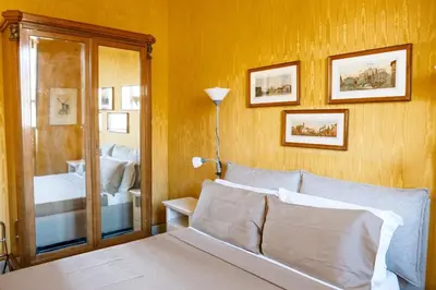 a bedroom with a bed and a mirror at Caesarina Roma, Luxury apartment in Rome