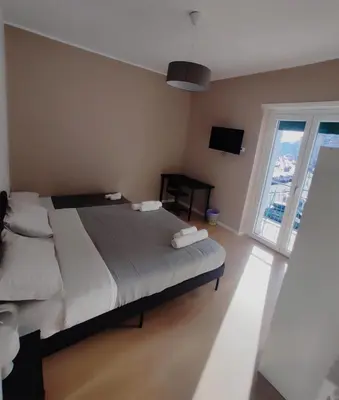 a bedroom with a bed and a large window at TiburtinaStay in Rome