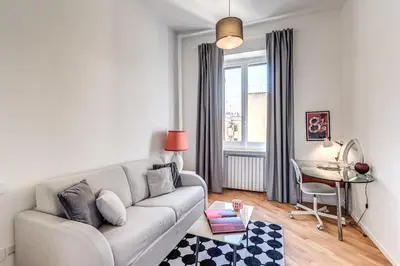 a living room with a couch and a table at Porta maggiore 2 bedroom with terrace in Rome