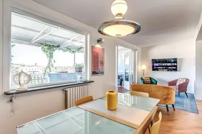 a dining room with a glass table and a window at Porta maggiore 2 bedroom with terrace in Rome